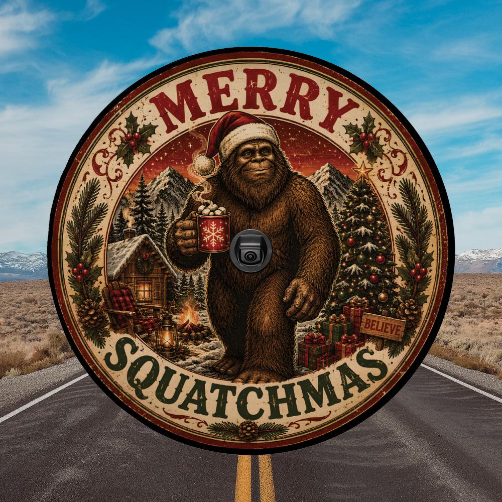 A circular novelty license plate cover featuring a festive 'Merry Squatchmas' design with a Bigfoot in a Santa hat holding a mug, set against a background of an interstate highway and desert landscape.