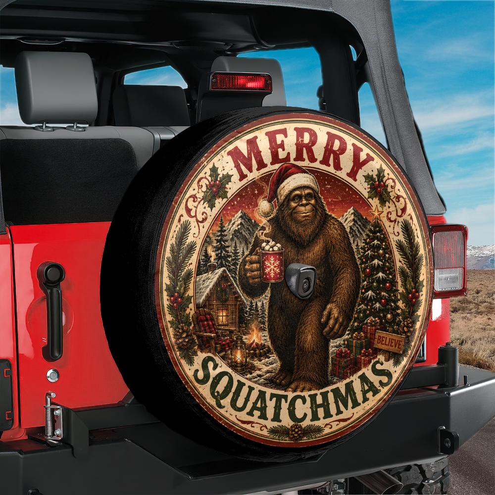 A circular tire cover mounted on the spare tire of a red Jeep, featuring a festive Christmas design with a Bigfoot figure in a Santa hat holding a mug, surrounded by the text 'MERRY' and 'SQUATCHMAS'.